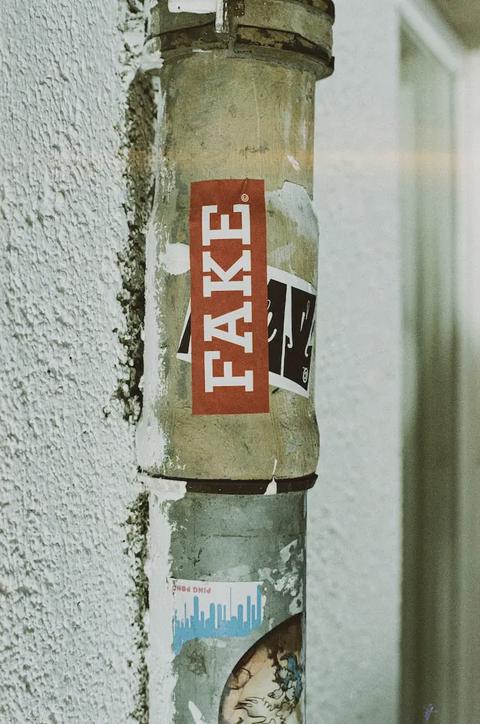 A pipe with a sticker spelling out the word FAKE